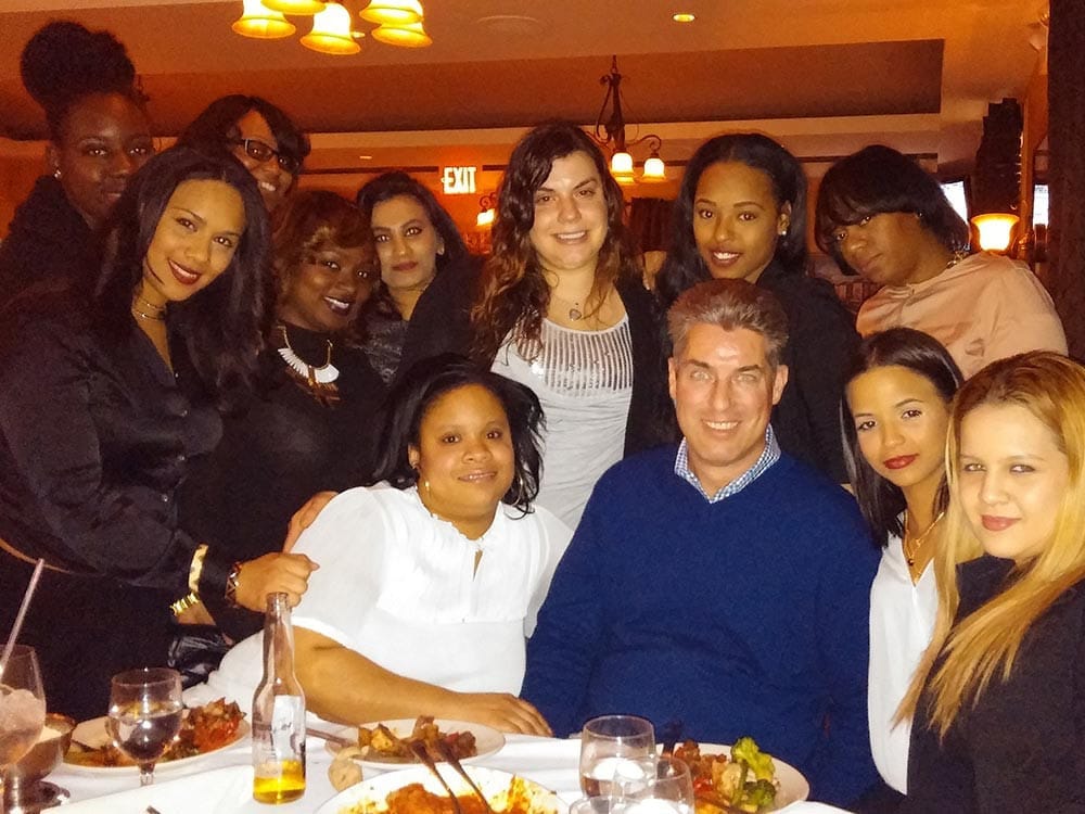 Dr. Weiss and Staff smiling at table